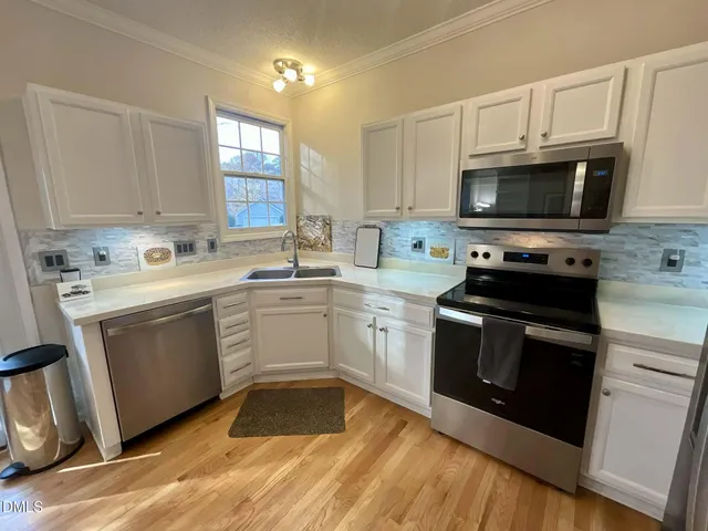 a kitchen with a refrigerator stove and microwave