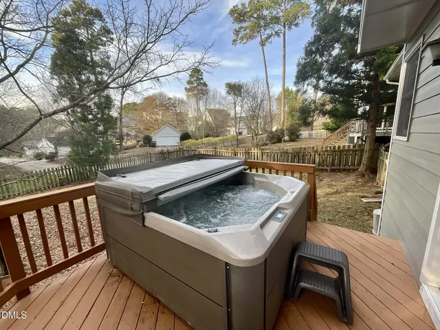 a view of roof deck with wooden floor and fence