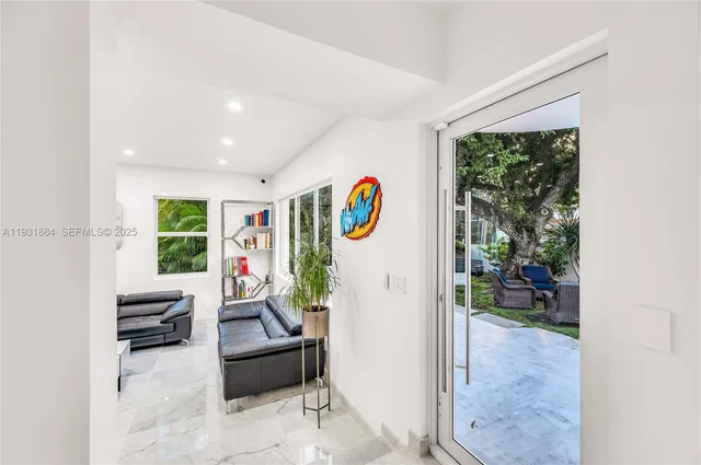 a living room with furniture and air hockey table