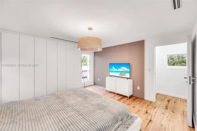 a bedroom with a bed and a chandelier