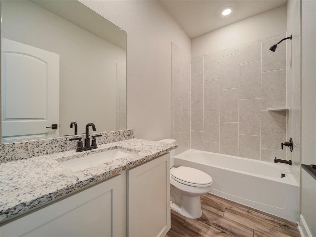 809 Calhoun Drive Anna, TX 75409 - Photo 12 of 12 a bathroom with a granite countertop sink toilet and shower