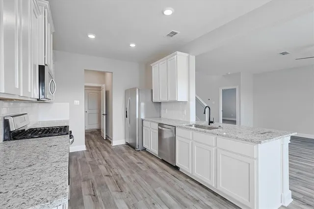 a kitchen with a sink stove and refrigerator