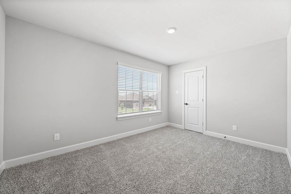809 Calhoun Drive Anna, TX 75409 - Photo 6 of 12 a view of an empty room with a window