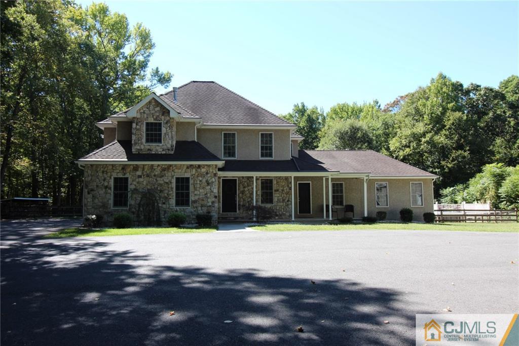 252 Deans Rhode Hall Road Monroe Township, NJ 08831 - Photo 1 of 25 a front view of a house with a yard