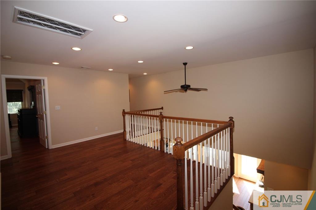 252 Deans Rhode Hall Road Monroe Township, NJ 08831 - Photo 17 of 25 a view of a hallway with wooden floor and stairs