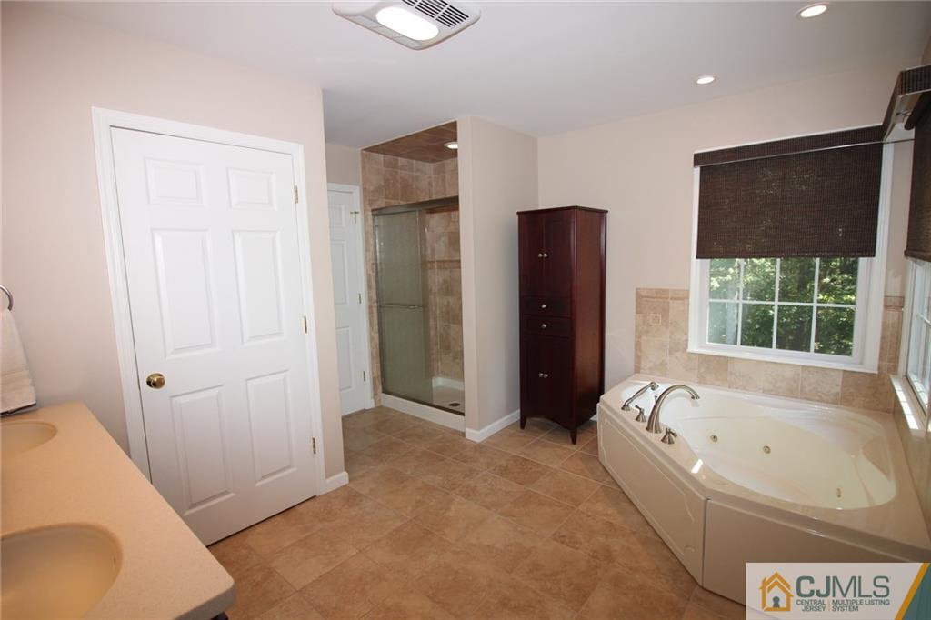 252 Deans Rhode Hall Road Monroe Township, NJ 08831 - Photo 19 of 25 a bathroom with a bathtub and a shower