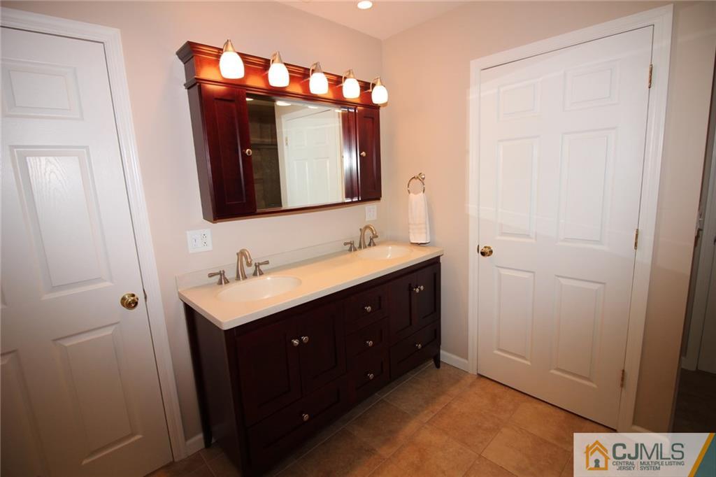 252 Deans Rhode Hall Road Monroe Township, NJ 08831 - Photo 21 of 25 a bathroom with a sink vanity and a mirror
