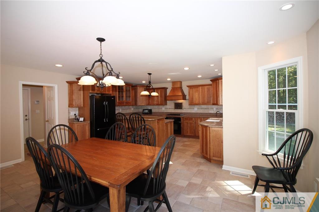 252 Deans Rhode Hall Road Monroe Township, NJ 08831 - Photo 8 of 25 a view of a dining room with furniture and wooden floor