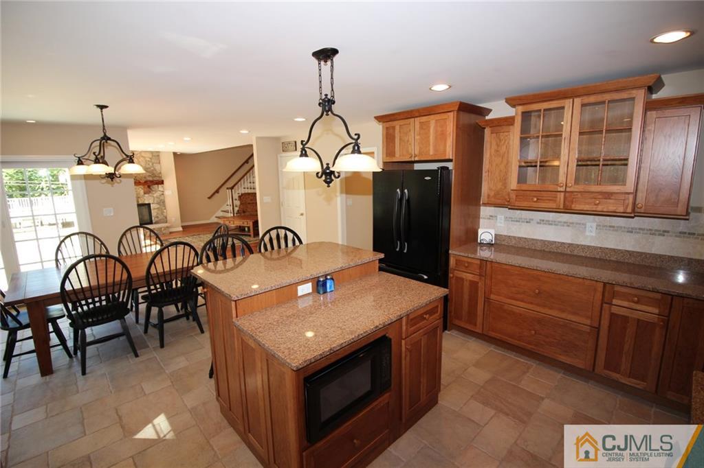252 Deans Rhode Hall Road Monroe Township, NJ 08831 - Photo 10 of 25 a kitchen that has a lot of cabinets and stainless steel appliances