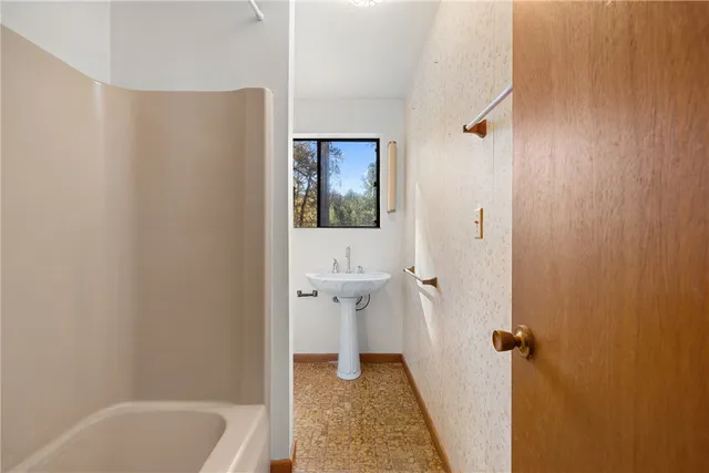 a bathroom with a sink and mirror with toilet