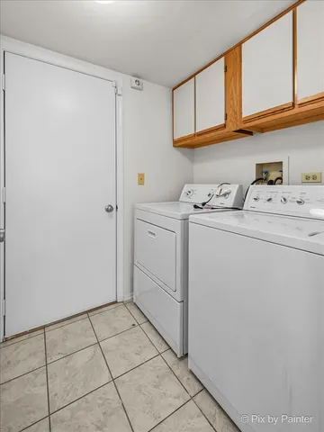 a view of storage and utility room with washer and dryer