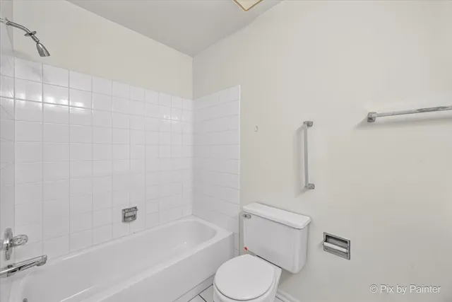 a bathroom with a toilet and a bathtub