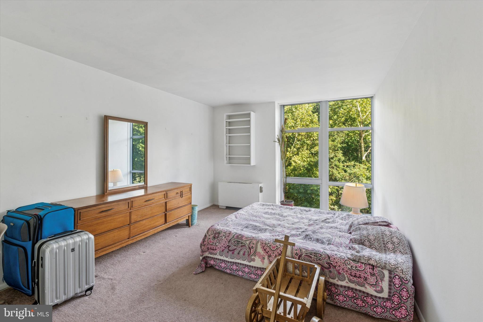 3600 Conshohocken Avenue, Unit 116 Philadelphia, PA 19131 - Photo 14 of 25 a bedroom with a bed chair and window