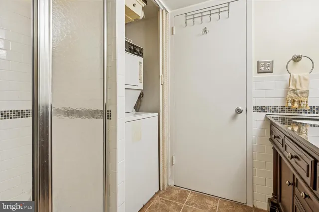 a view of bathroom with utility room and washer