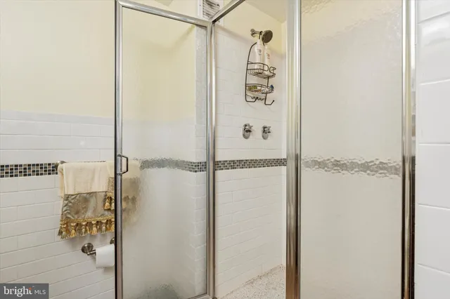 a bathroom with a shower and a glass door