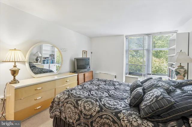 a bedroom with a large bed and a window