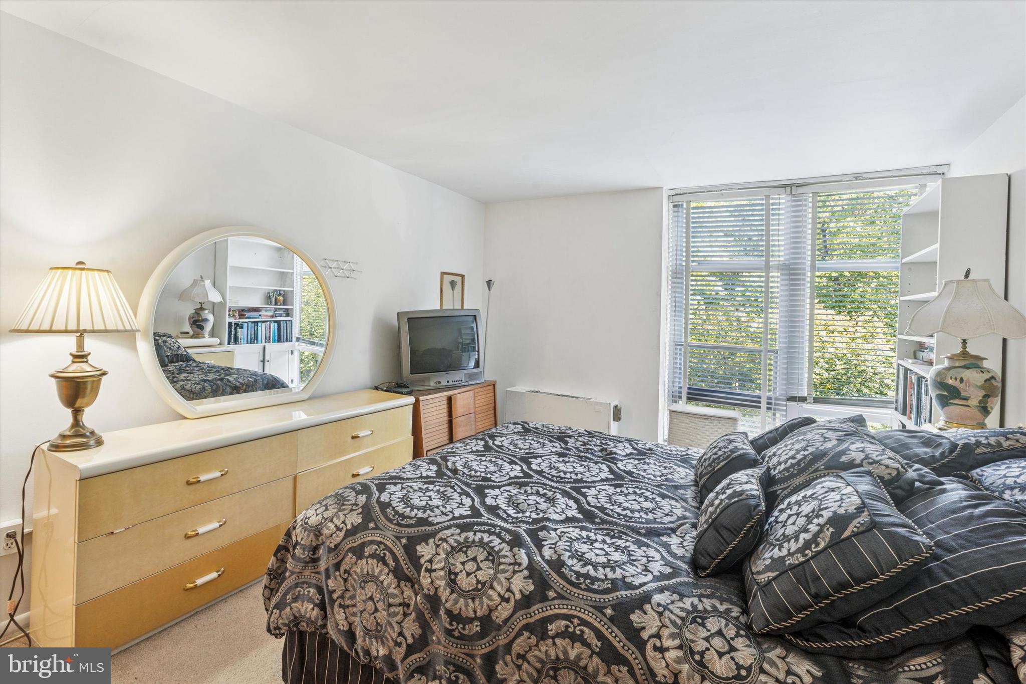 3600 Conshohocken Avenue, Unit 116 Philadelphia, PA 19131 - Photo 22 of 25 a bedroom with a large bed and a window