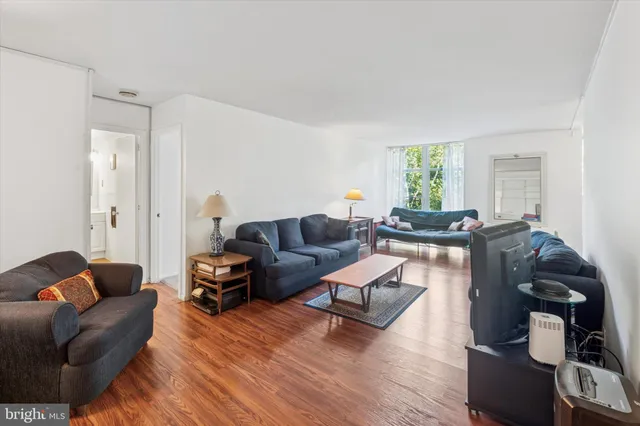 a living room with furniture or couch and a wooden floor