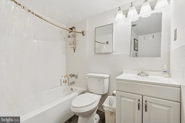 a bathroom with a sink toilet tub and shower