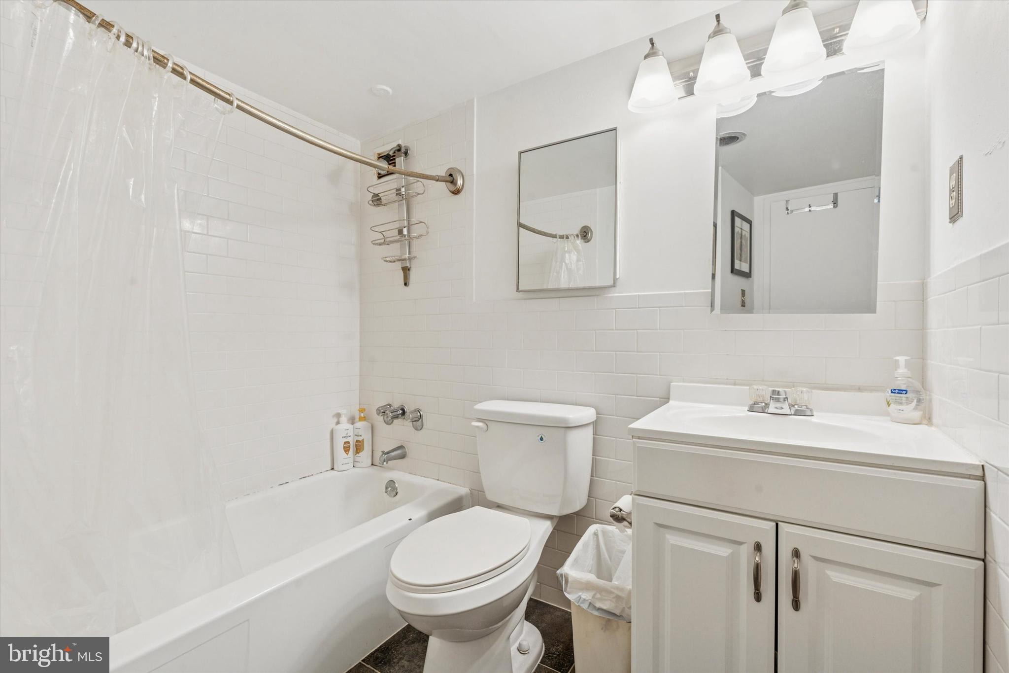3600 Conshohocken Avenue, Unit 116 Philadelphia, PA 19131 - Photo 7 of 25 a bathroom with a sink toilet tub and shower