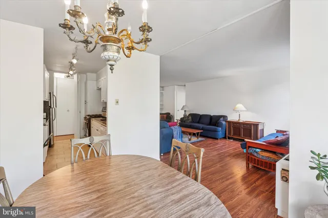 a bedroom with a bed dresser and wooden floor