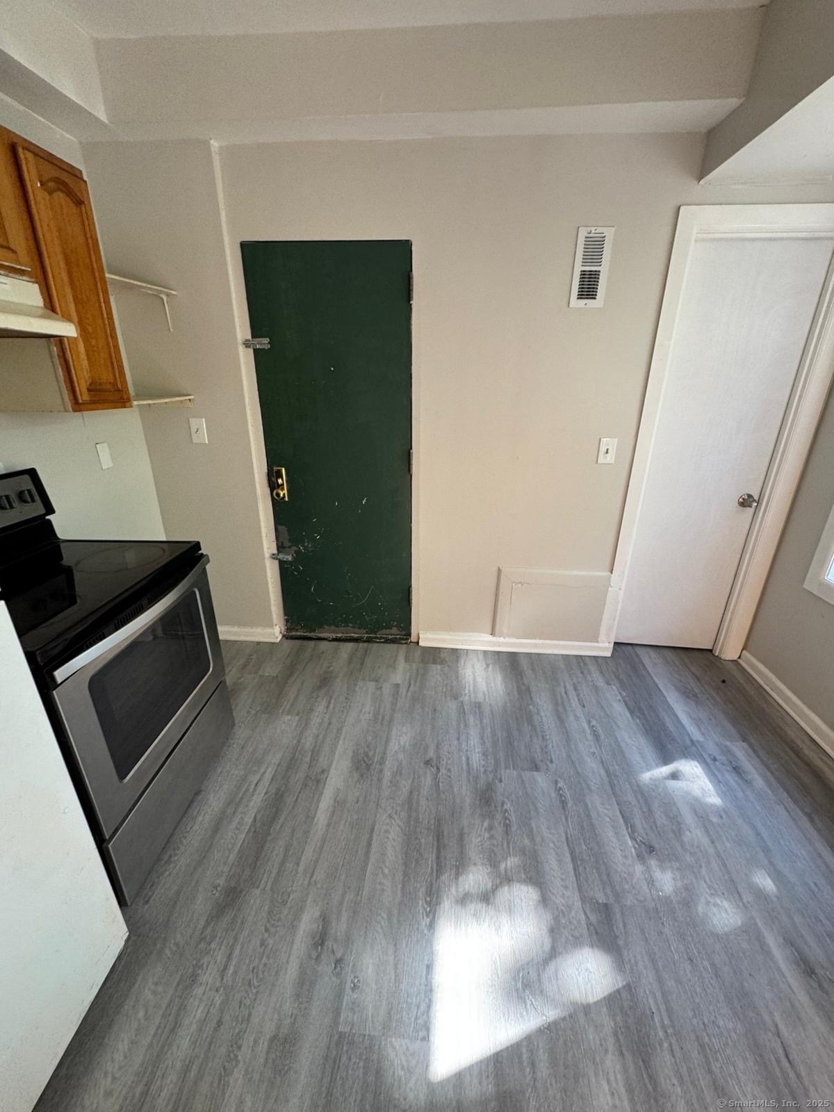 1071 Pembroke Street, Unit 2E Bridgeport, CT 06608 - Photo 3 of 8 a view of a kitchen from a hallway