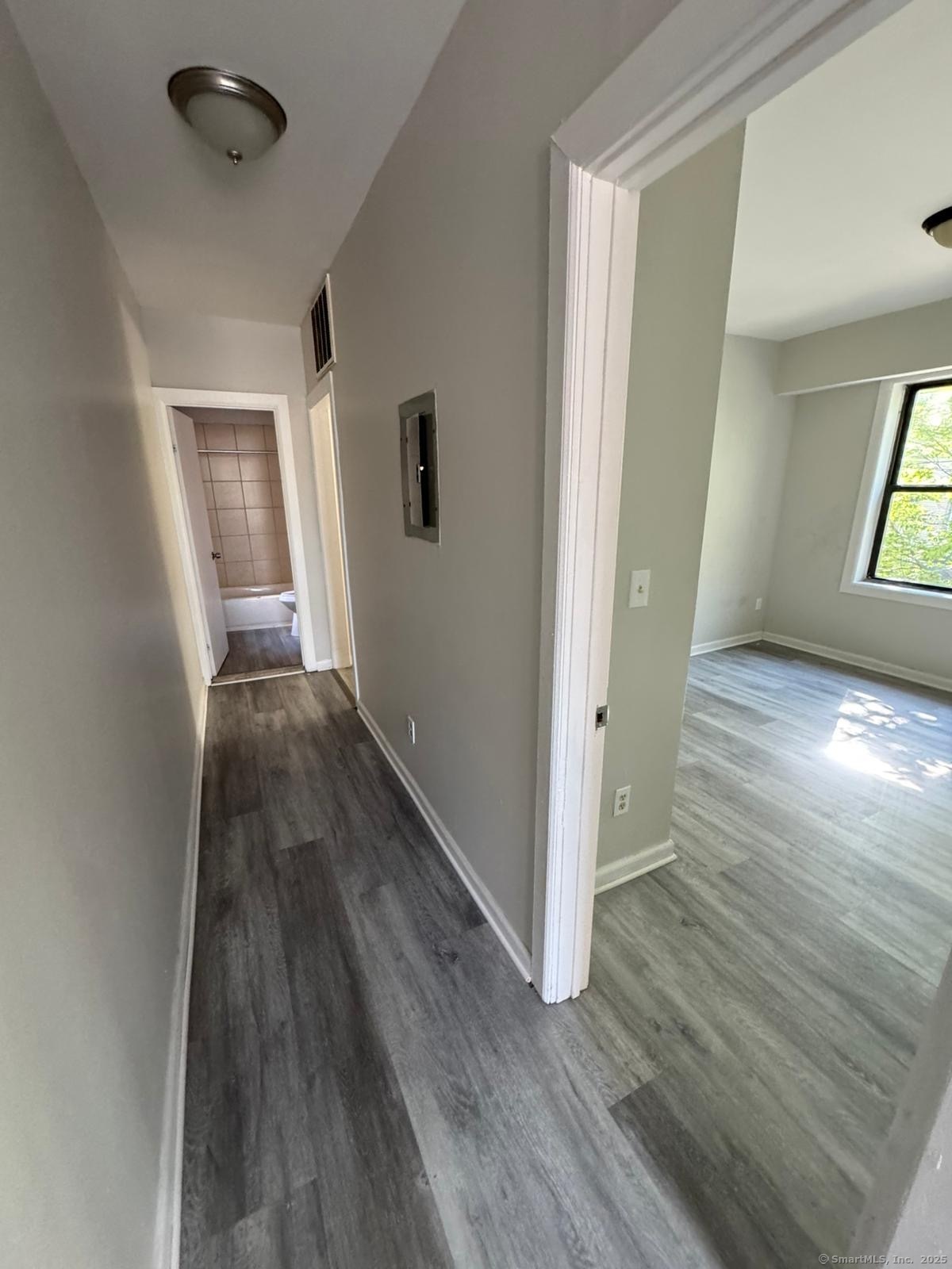 1071 Pembroke Street, Unit 2E Bridgeport, CT 06608 - Photo 7 of 8 wooden floor in an empty room with a window