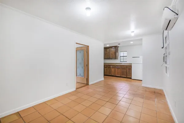a view of a kitchen with a sink and a refrigerator