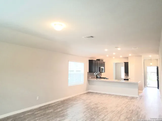 a view of a kitchen with a sink and a window