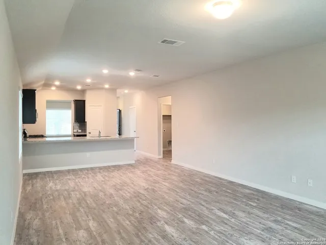 a view of large kitchen with a sink and a stove