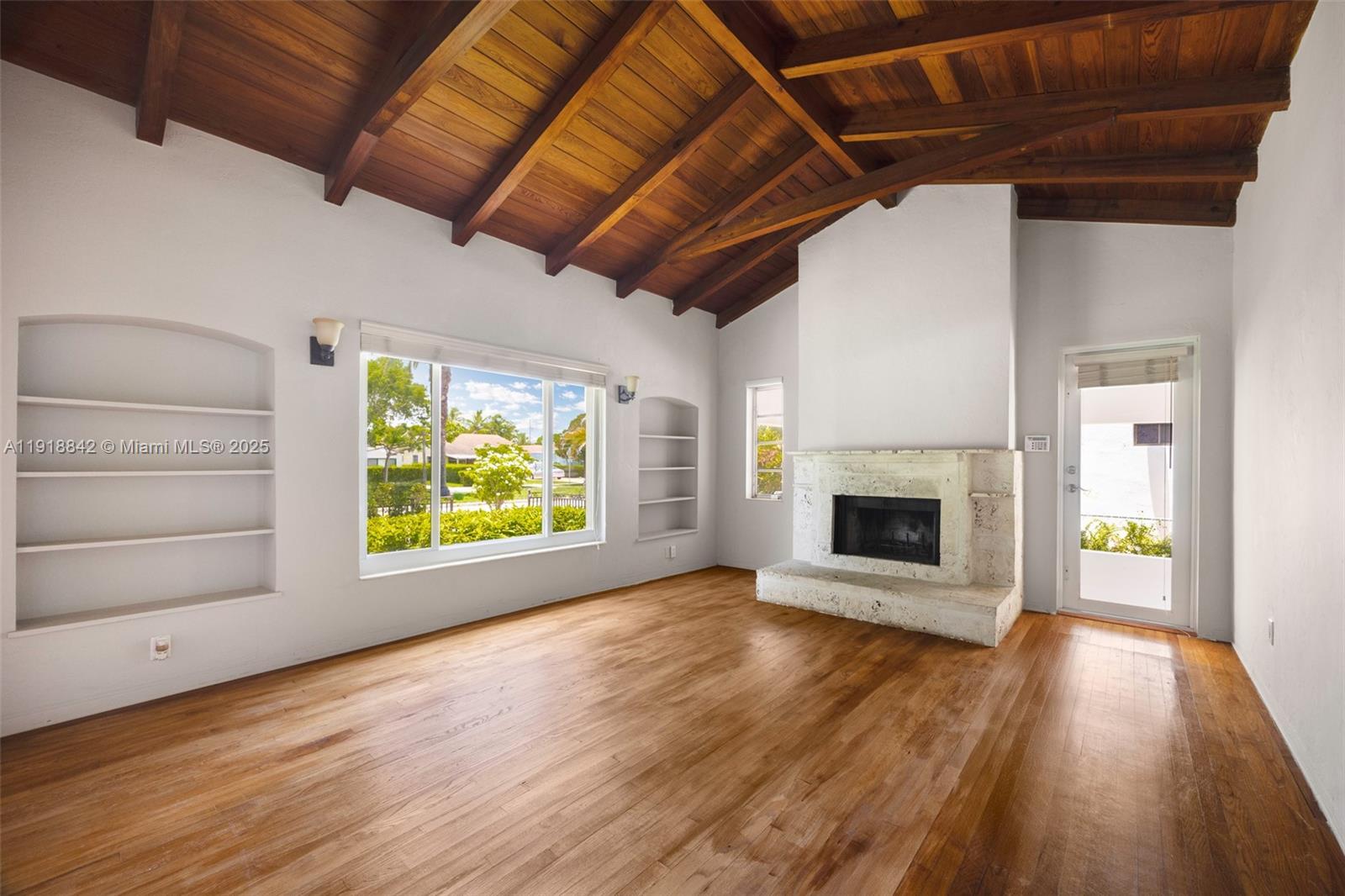 451 Southwest 25th Road, Unit 451 Miami, FL 33129 - Photo 2 of 10 a view of an empty room with a fireplace and a window