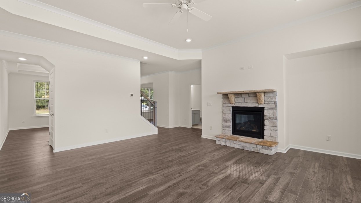 416 Hazel Drive Locust Grove, GA 30248 - Photo 15 of 31 an empty room with wooden floor and a fireplace