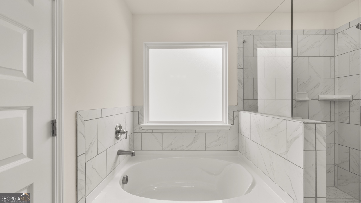 416 Hazel Drive Locust Grove, GA 30248 - Photo 19 of 31 a white bath tub sitting in a bathroom
