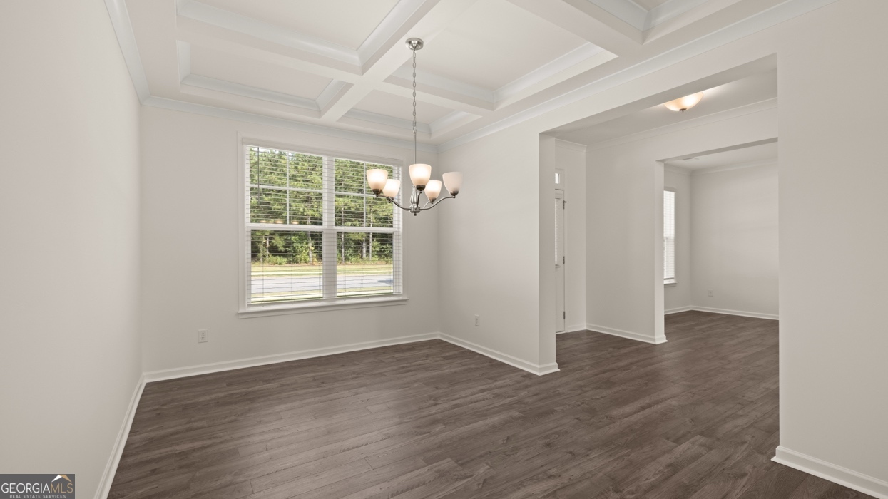 416 Hazel Drive Locust Grove, GA 30248 - Photo 5 of 31 an empty room with wooden floor and windows