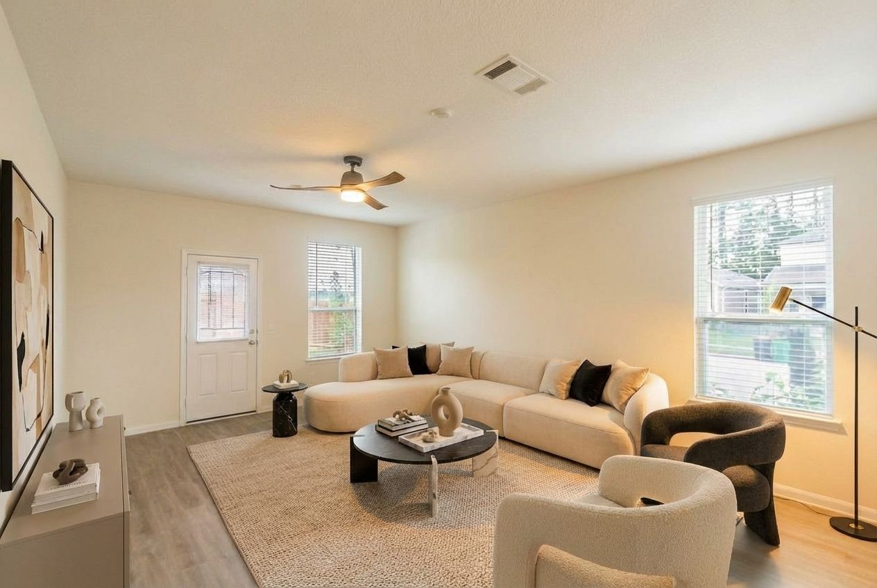 23502 Glenbuck St Spring Spring, TX 77373 - Photo 14 of 50 This virtually staged living room offers a warm and inviting space with a sleek, modern design, featuring a cozy sectional sofa, stylish accent chairs, and abundant natural light.