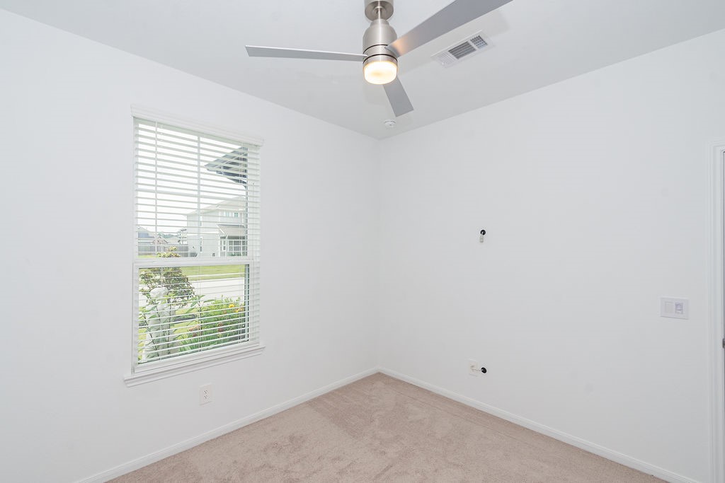 23502 Glenbuck St Spring Spring, TX 77373 - Photo 23 of 50 This is a bright, small room with white walls, a ceiling fan, and a window with blinds, offering a view of the outdoors. Ideal for a home office or nursery.
