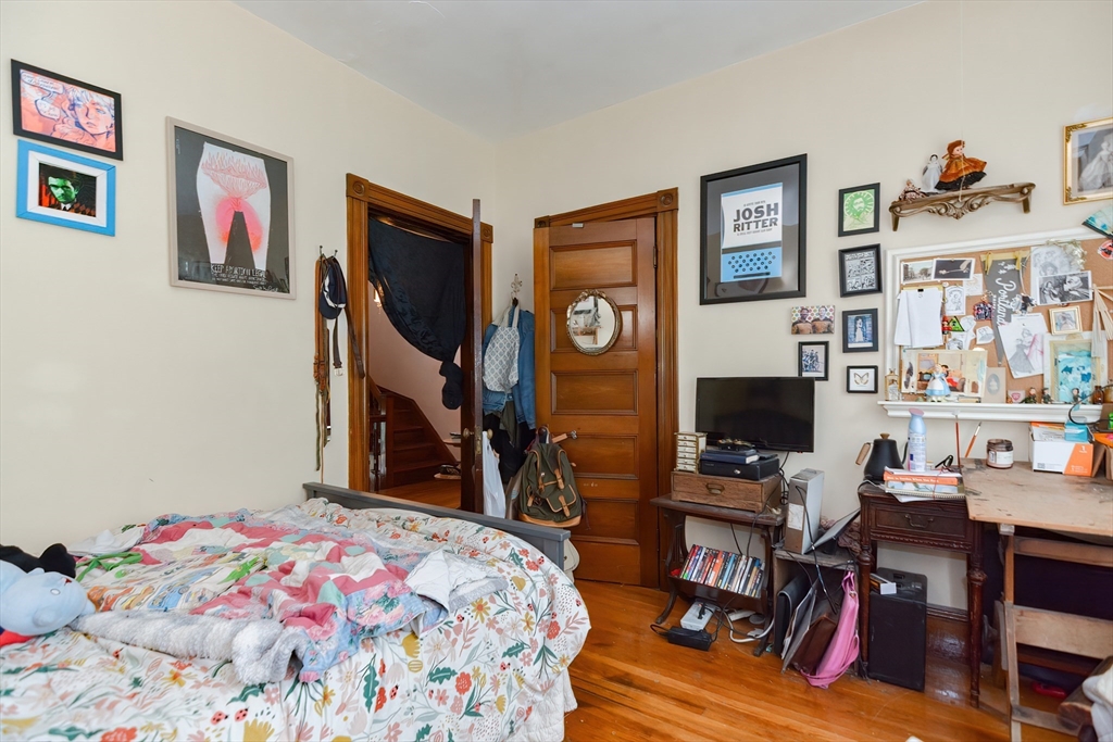 52 Tower Street Boston, MA 02130 - Photo 16 of 29 a bedroom with a bed and a bookshelf