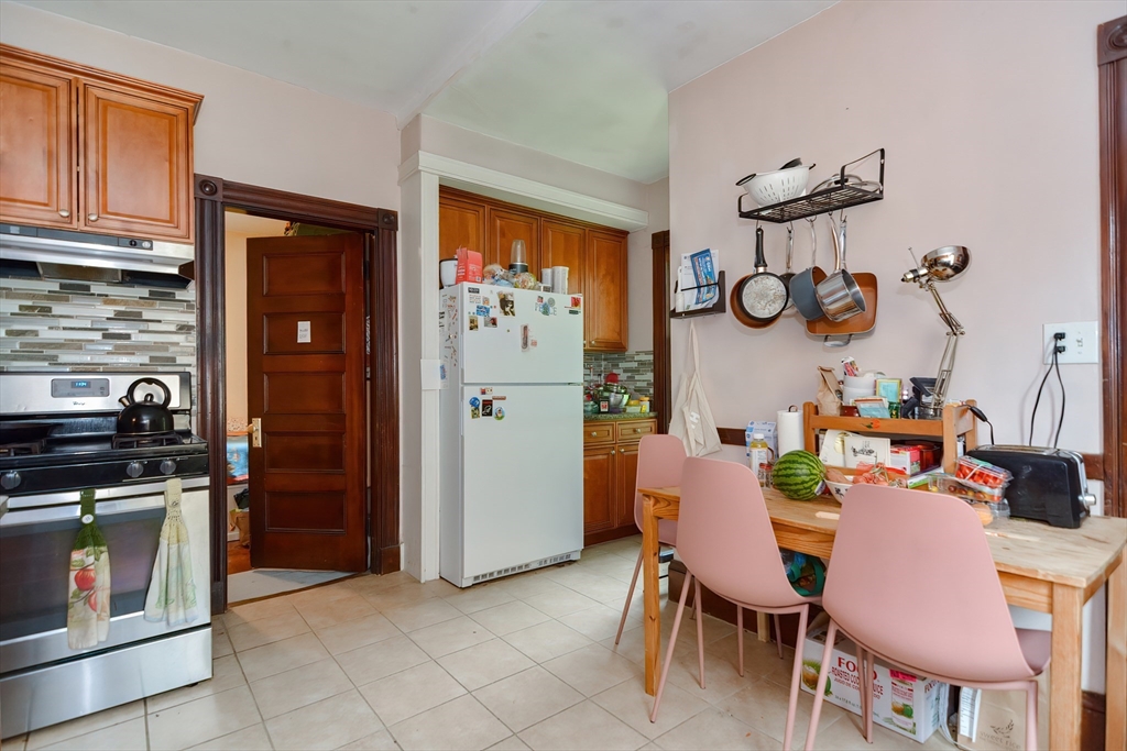 52 Tower Street Boston, MA 02130 - Photo 18 of 29 a dining room with furniture and kitchen view