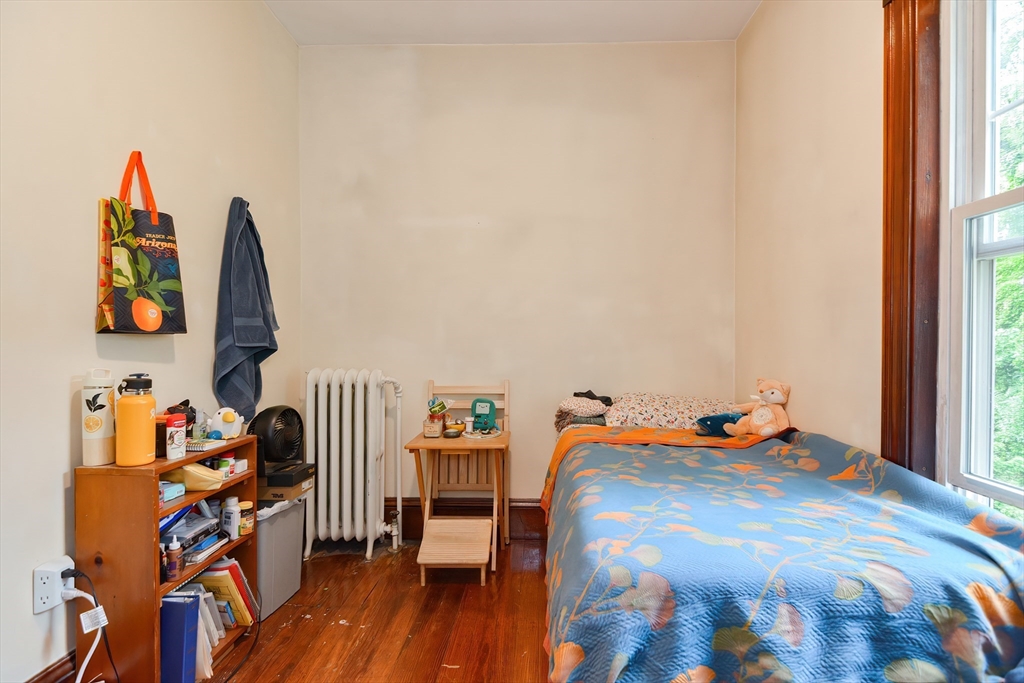 52 Tower Street Boston, MA 02130 - Photo 20 of 29 a bedroom with a bed and wooden floor