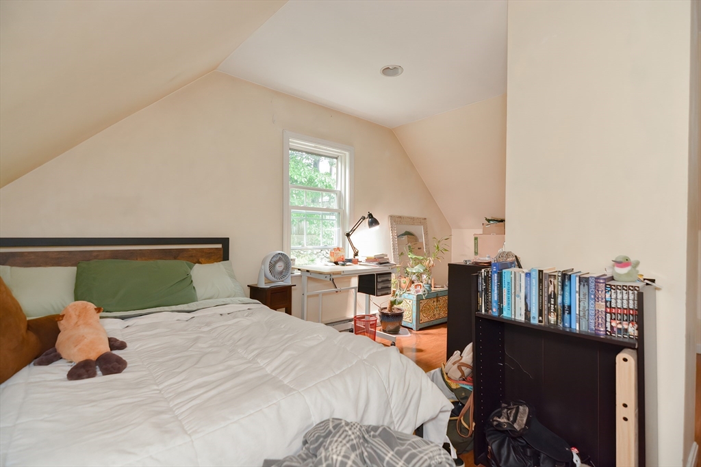52 Tower Street Boston, MA 02130 - Photo 23 of 29 a bedroom with a bed and a book shelf
