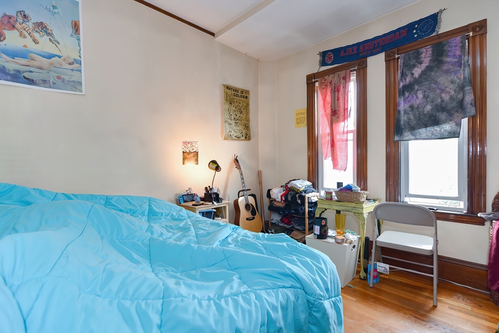 52 Tower Street Boston, MA 02130 - Photo 26 of 29 a bed sitting in a bedroom next to a window