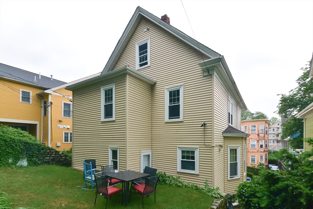 52 Tower Street Boston, MA 02130 - Photo 29 of 29 a view of a house with a yard and plants