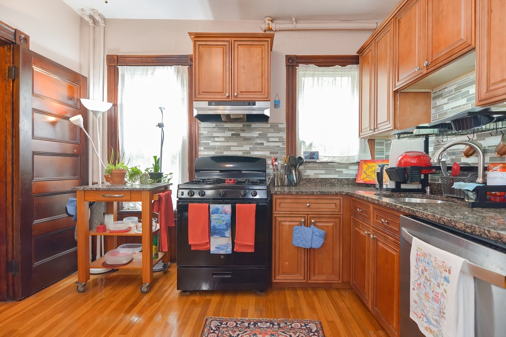 52 Tower Street Boston, MA 02130 - Photo 6 of 29 a kitchen with stainless steel appliances granite countertop a stove a sink and a refrigerator