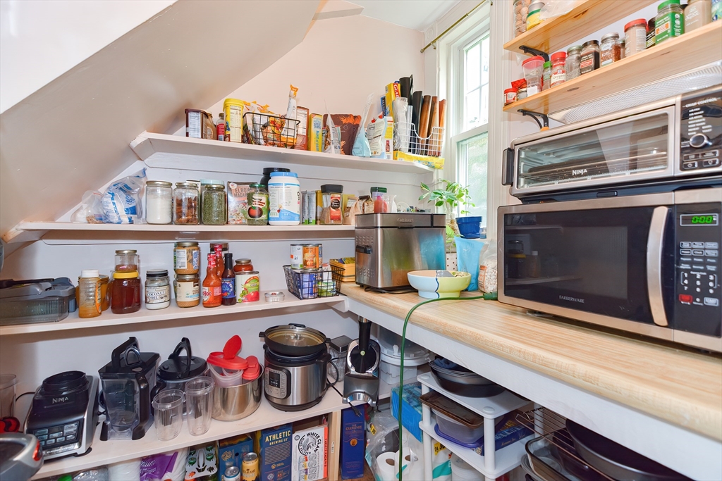 52 Tower Street Boston, MA 02130 - Photo 8 of 29 a kitchen with stainless steel appliances a cabinet and a book shelf