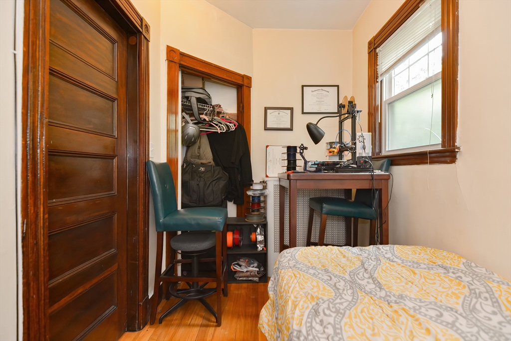 52 Tower Street Boston, MA 02130 - Photo 10 of 29 a bedroom with a bed and a flat tv screen next to a window