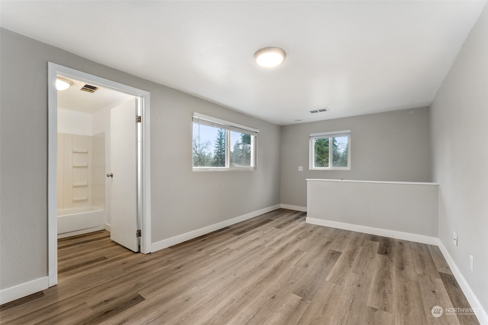 8520 Meadow Road Southwest Lakewood, WA 98499 - Photo 14 of 24 a view of an empty room with wooden floor and a window