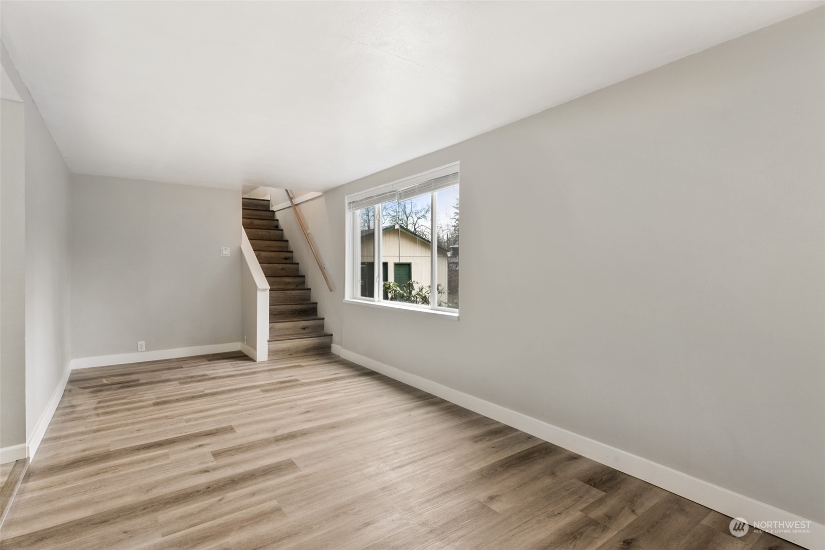 8520 Meadow Road Southwest Lakewood, WA 98499 - Photo 3 of 24 a view of an empty room with wooden floor and a window