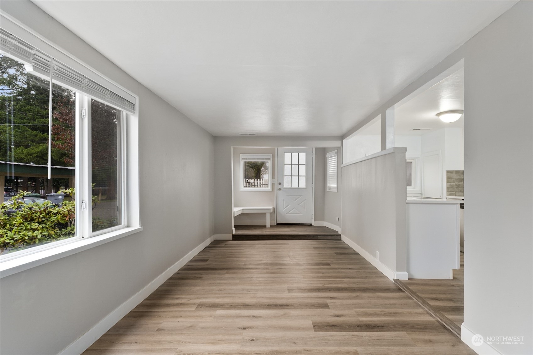8520 Meadow Road Southwest Lakewood, WA 98499 - Photo 4 of 24 a view of an empty room with wooden floor and a window