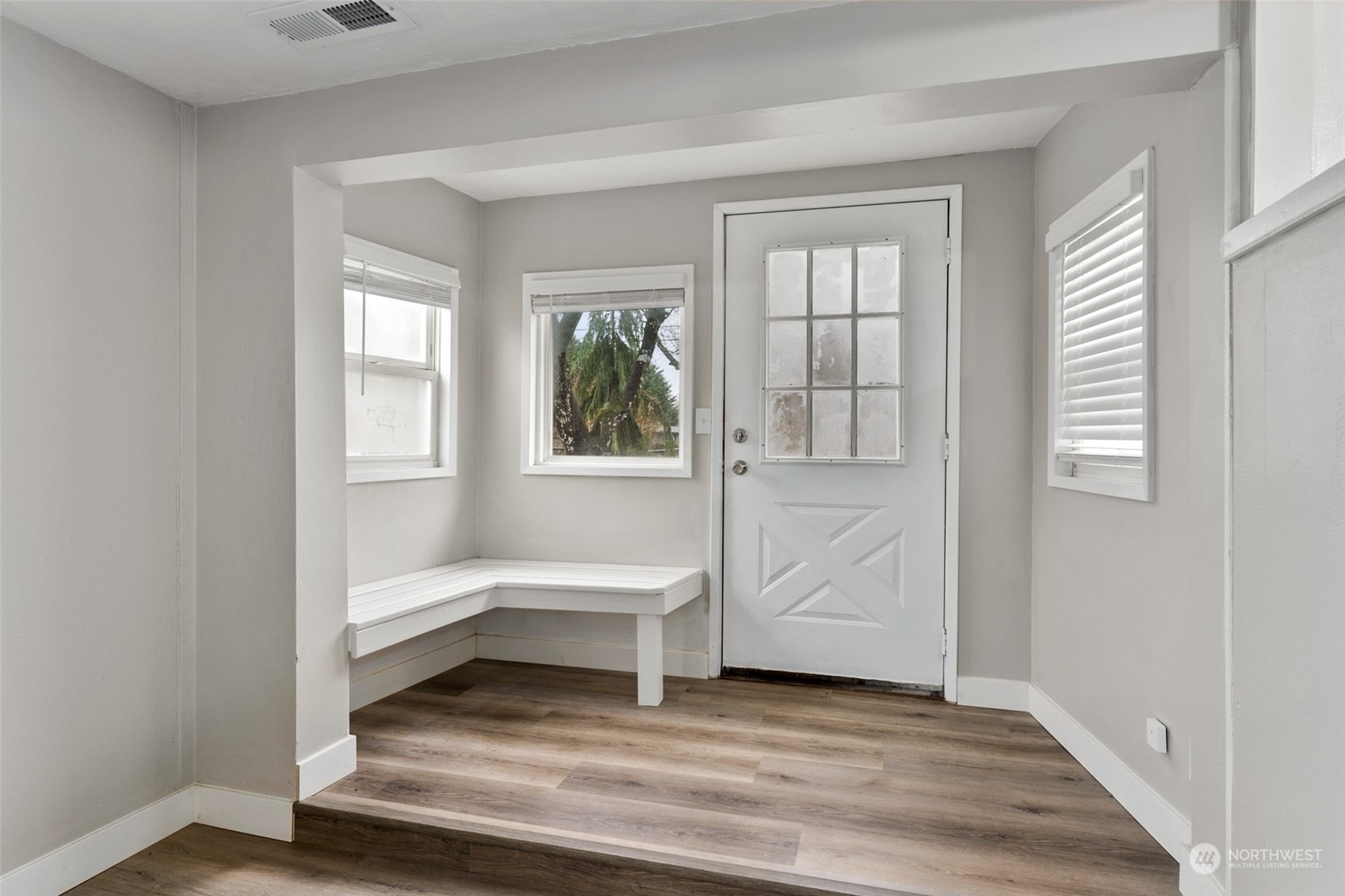 8520 Meadow Road Southwest Lakewood, WA 98499 - Photo 5 of 24 a view of a bedroom with wooden floor and windows