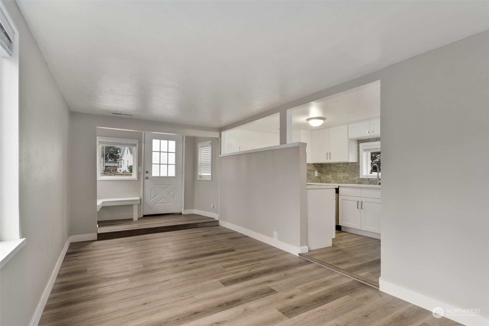 8520 Meadow Road Southwest Lakewood, WA 98499 - Photo 6 of 24 a view of empty room with wooden floor and kitchen